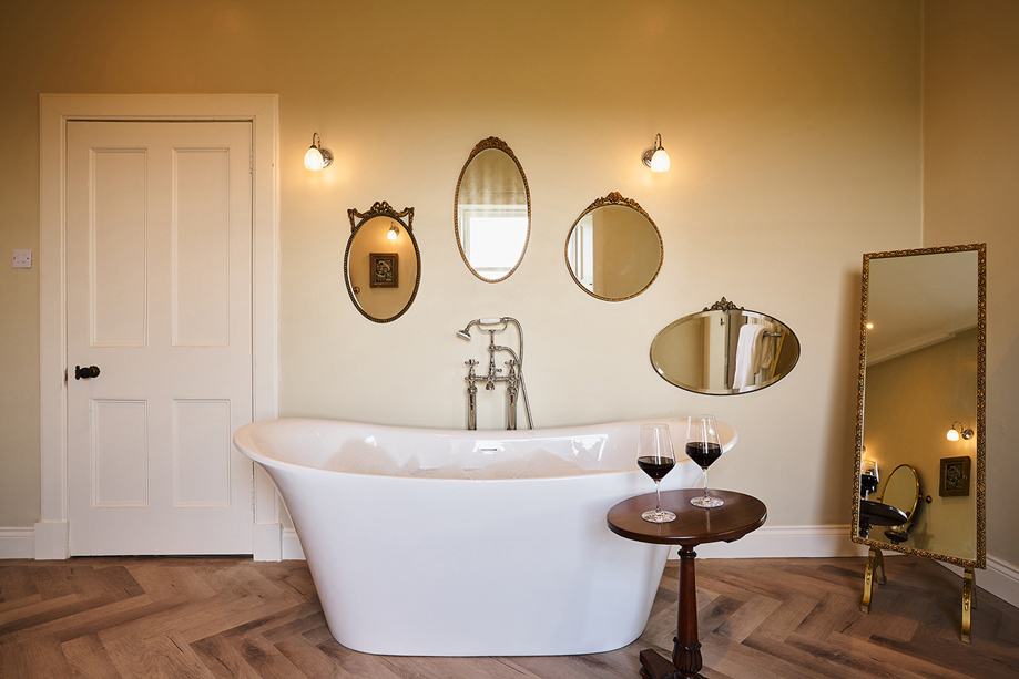 Large bath in Master Suite of Kinclune House decorated with vintage mirrors